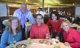 Larry with many bridge students enjoying a meal on a bridge cruise