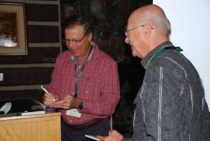 Larry autographing a book for a bridge player